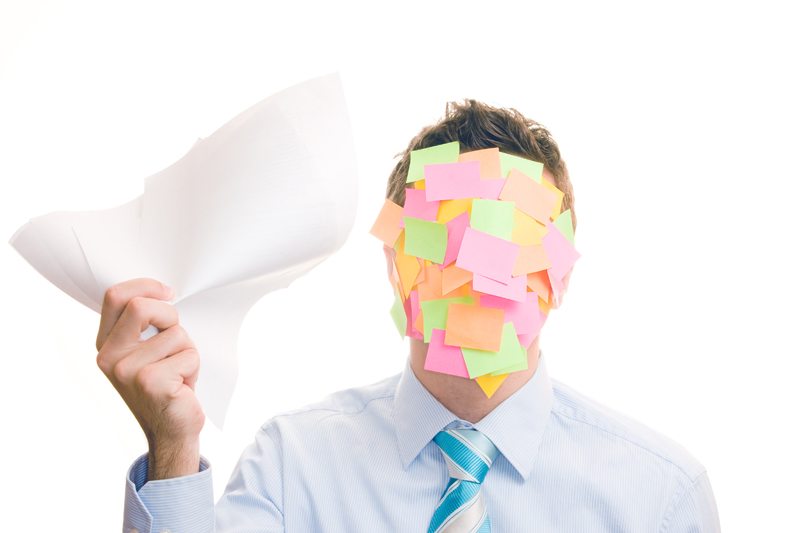 Businessman covered in stickers on white background