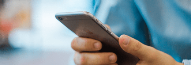 A person holding a cellphone in their hands.