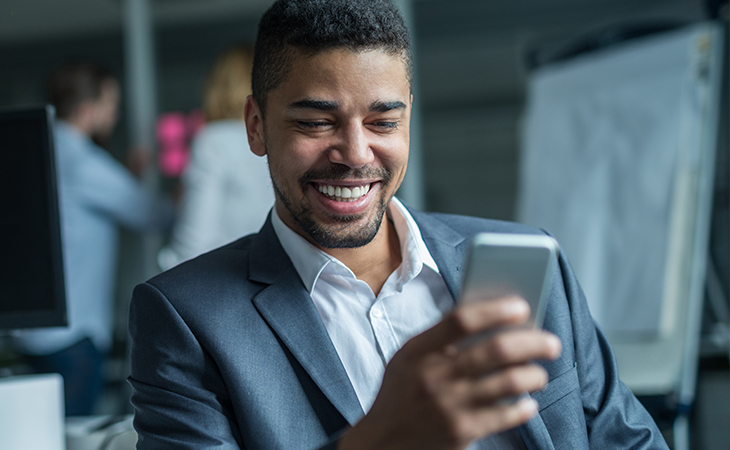 The Top 5 Ways to Use Everlytic's Dynamics 365 Plugin | Man looking at cell phone | Blog image