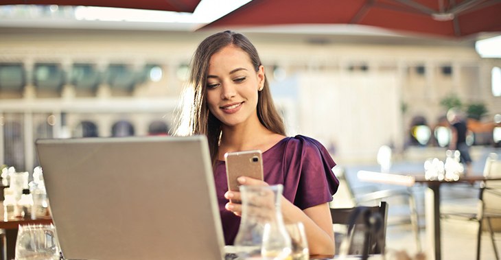 Everlytic | Blog | Use WhatsApp Click-to-Chat for Real-Time Business Communication | Blog Image | Cheerful Young Lady on Her Phone