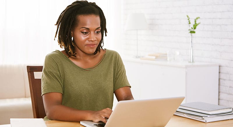 Everlytic | Blog | Write Strong Email Subject Lines to Boost Your Open Rate | African Woman Working on Laptop at Office