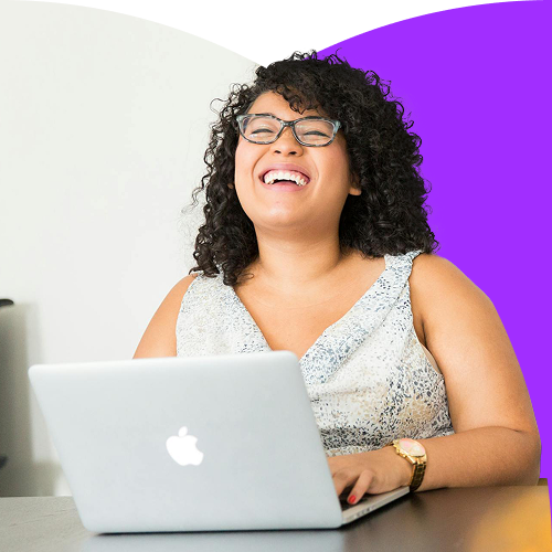 A women smiling and enjoying her email marketing campaign work