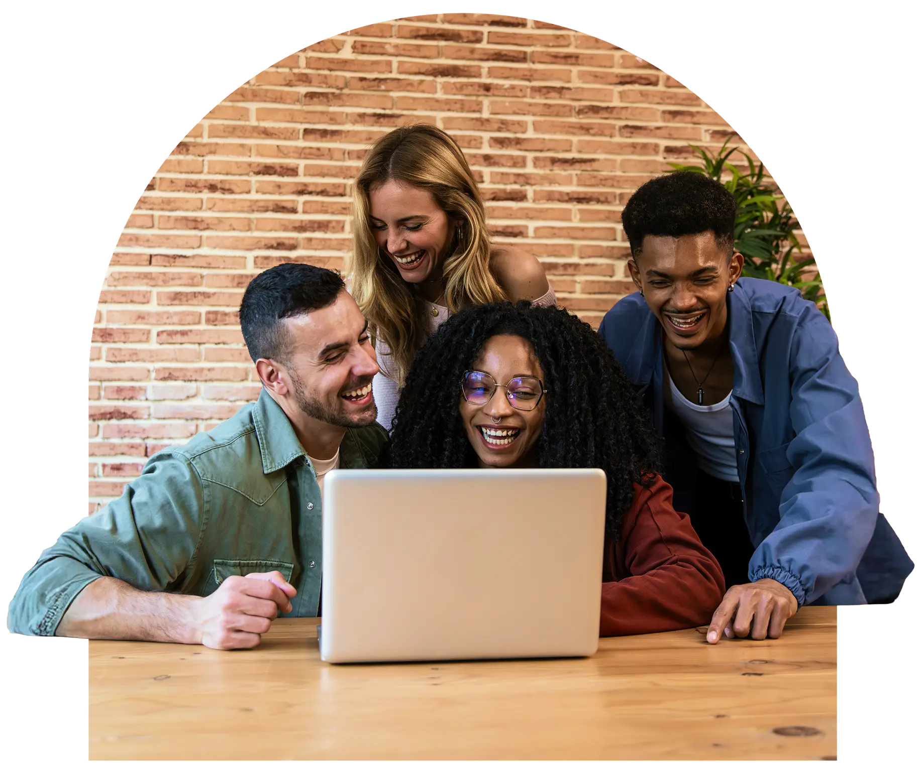 A group of team members sitting around a laptop.