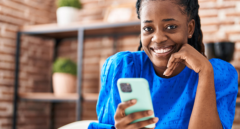 3 Steps to Maximising Your Mandela Day Emails_Everlytic Blog_Happy Lady on a Cell Phone