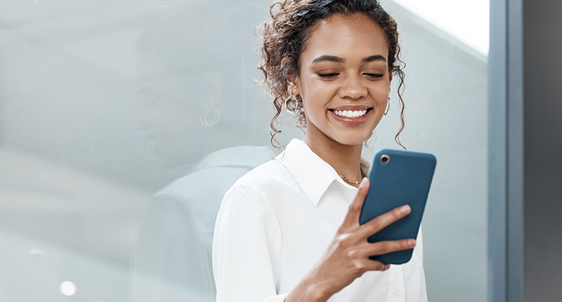 6 Subscription Form Best Practices for Effective Email Marketing_Everlytic Blog_Happy Woman Looking at Her Phone