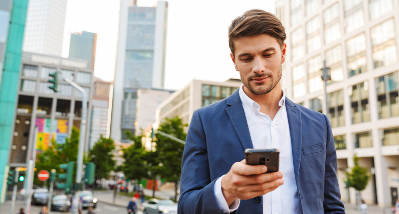 5 Bulk Email Marketing Mistakes & How to Avoid Them | Everlytic | Email Marketing | Bulk Email | Man Reading Something Off a Cell Phone