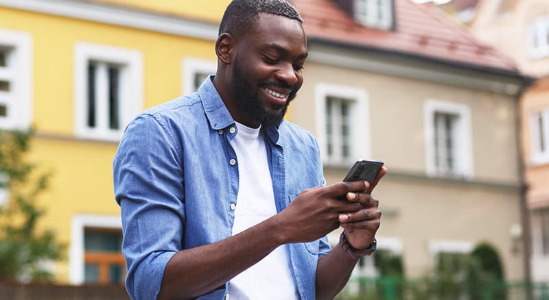 Man smiling at his phone