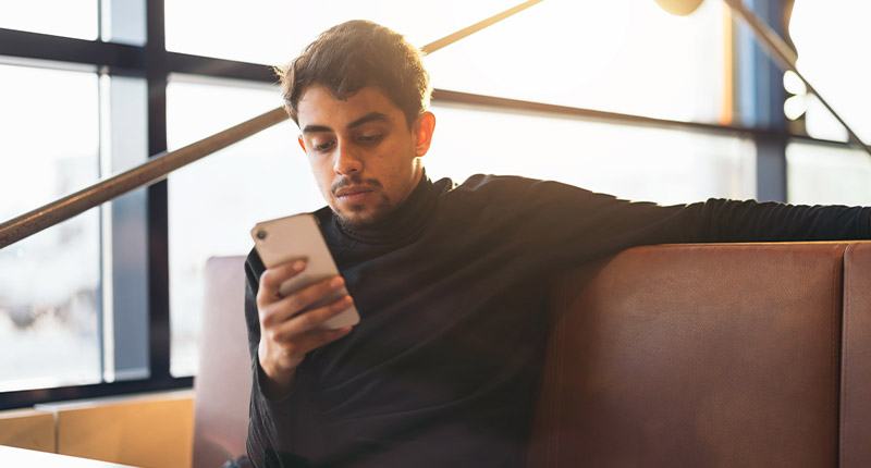 5 Data Compliance Traps to Avoid in SMS Marketing | Everlytic | Man reading off a cell phone