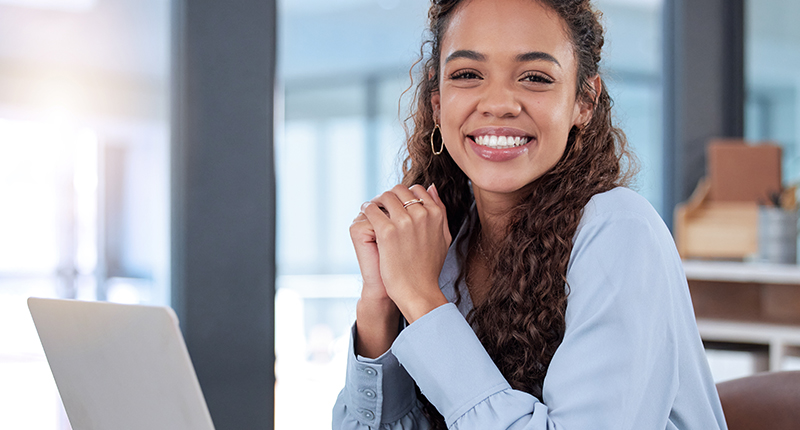 Simplify Communication Automation With Our New Zapier Integration_Everlytic Blog_Happy Woman Sitting at a Desk