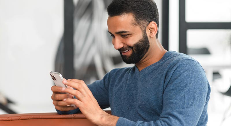 5 Powerful Tips for Crafting Engaging Transactional Email & SMS | Everlytic | Transactional Messaging | Well-Dressed Guys Looking at a Cell Phone